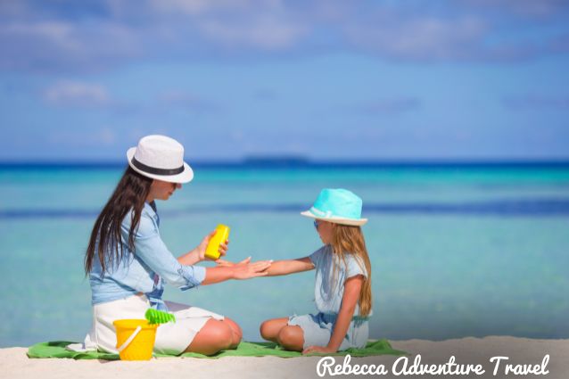 Mother and daughter using sunscreen.