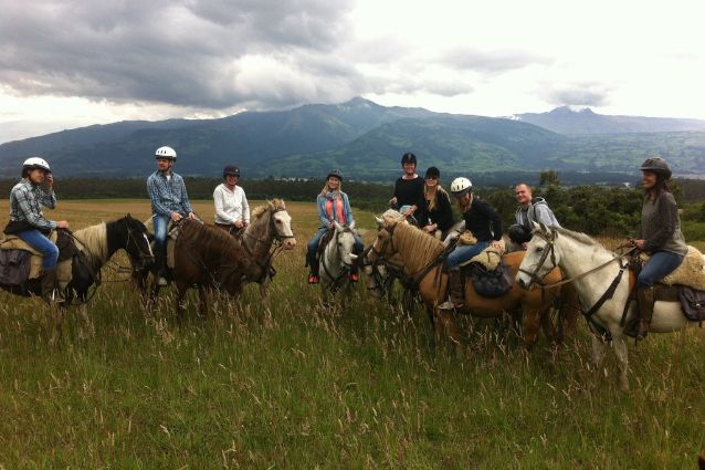 Group of travelers horseback riding at the Ecuadorian Andes.