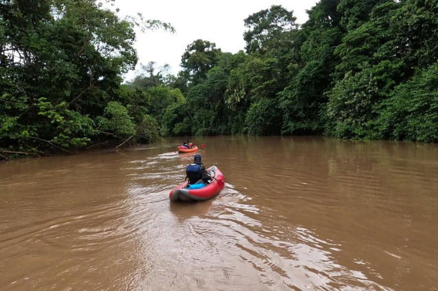 Travelers kayaking on a river in the Amazon