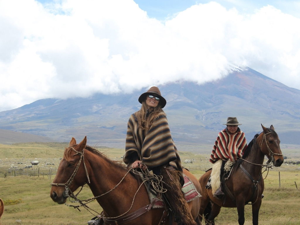 Traveler happy horseback riding.
