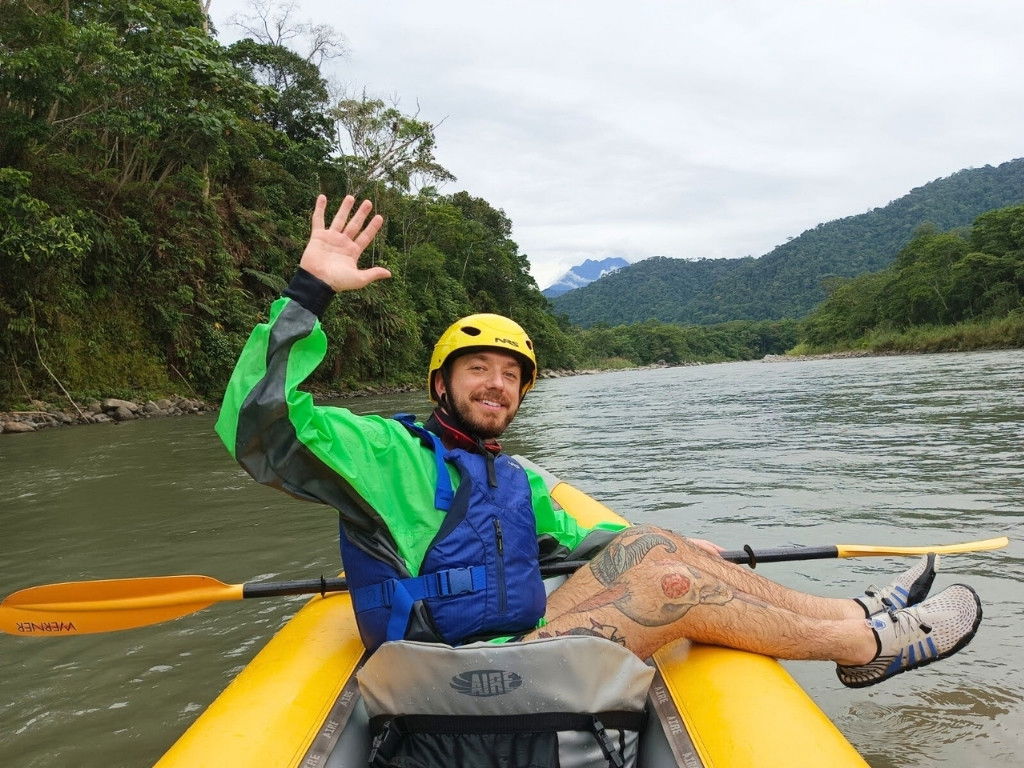Happy traveler kayaking around the Amazon