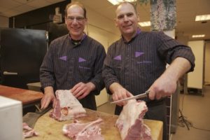 Slager Hofman snijdt vlees