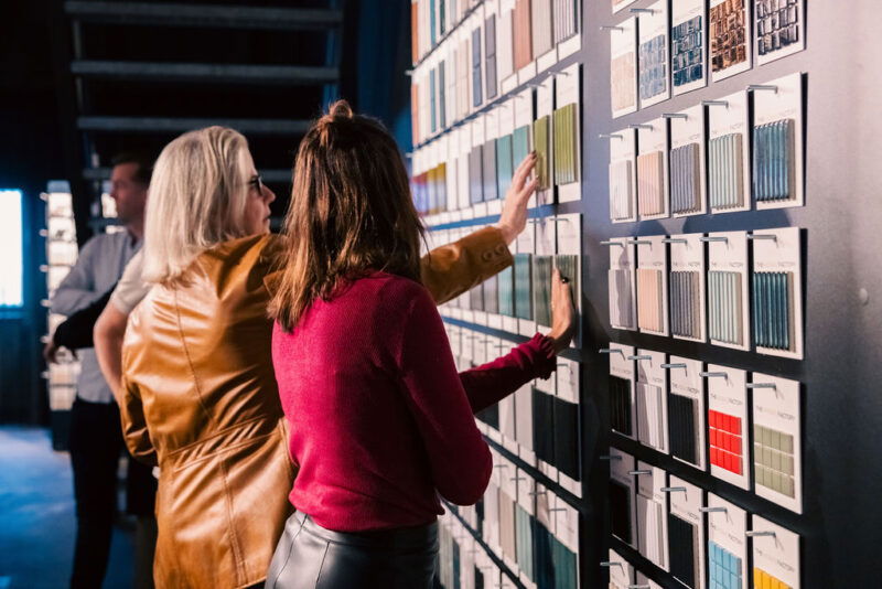 People looking at TMF samples on wall